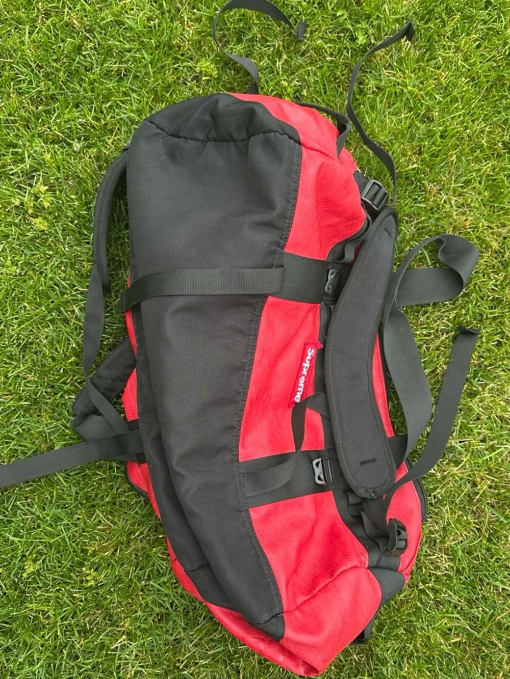 The North Face x Supreme Red Duffel Bag with Black Straps